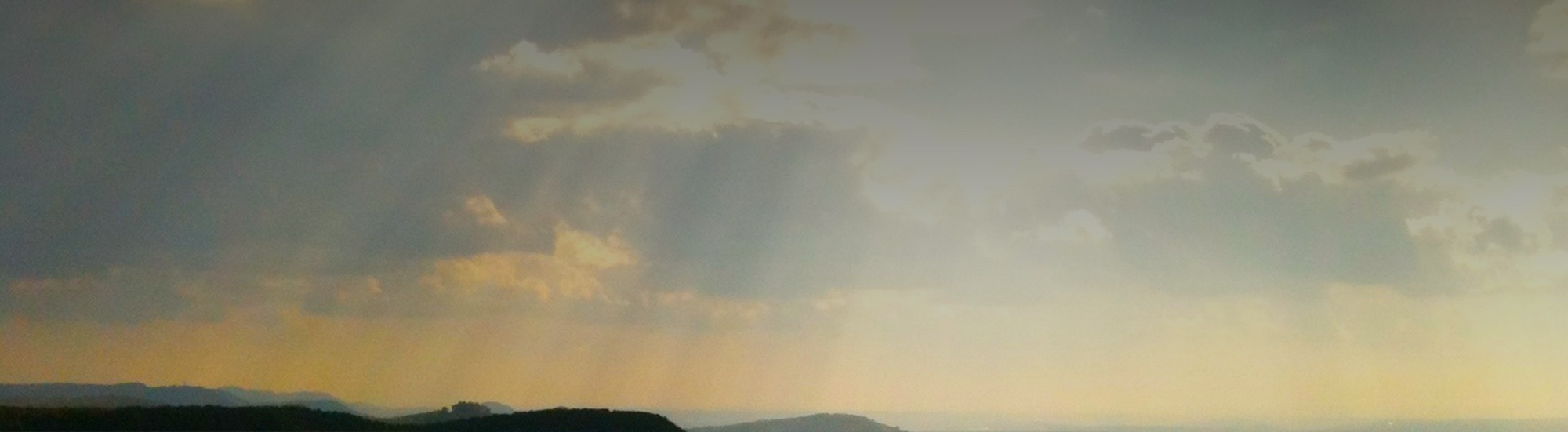 Sunset sky over a hilly landscape