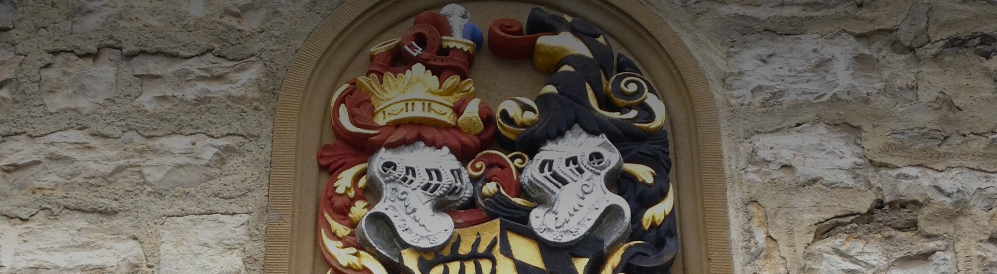 Carved coat of arms above a stone doorway
